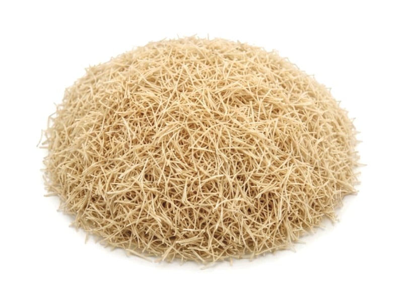 A mound of pale, unroasted kadayif strands on a white background
